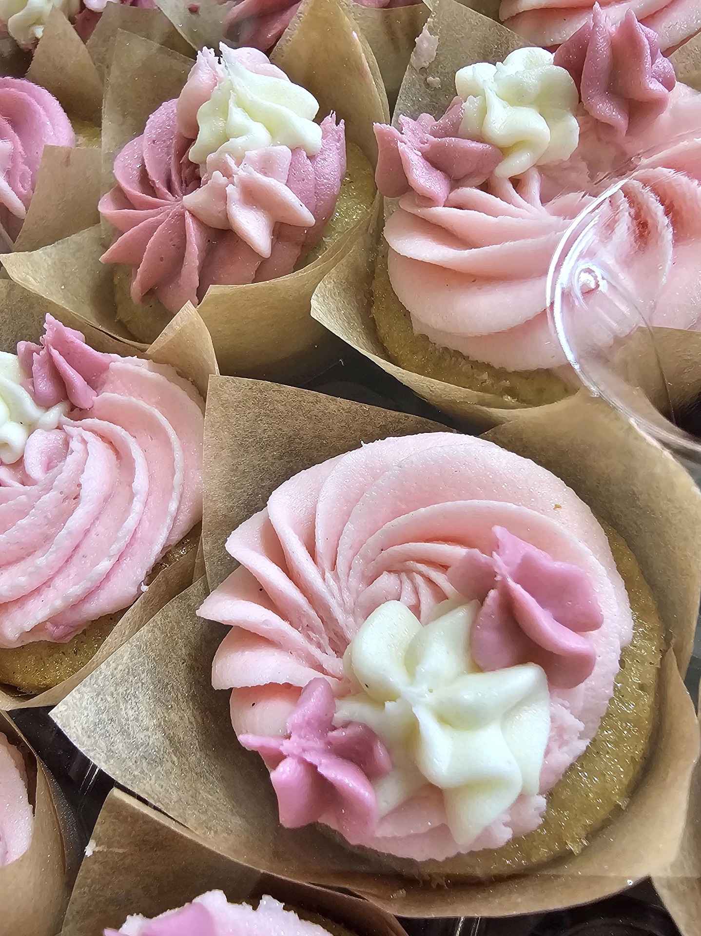 Close-up of pink buttercream rose cupcakes