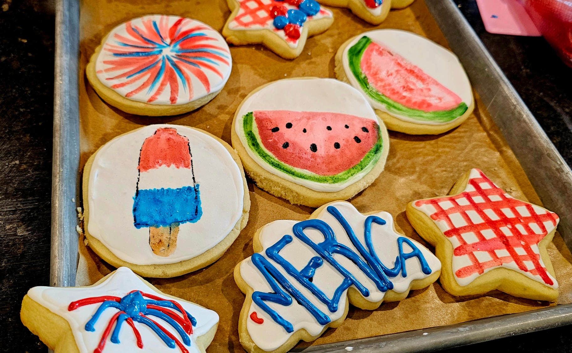 Hand-painted patriotic cookies — fireworks, watermelon, bomb pops, and 'Merica