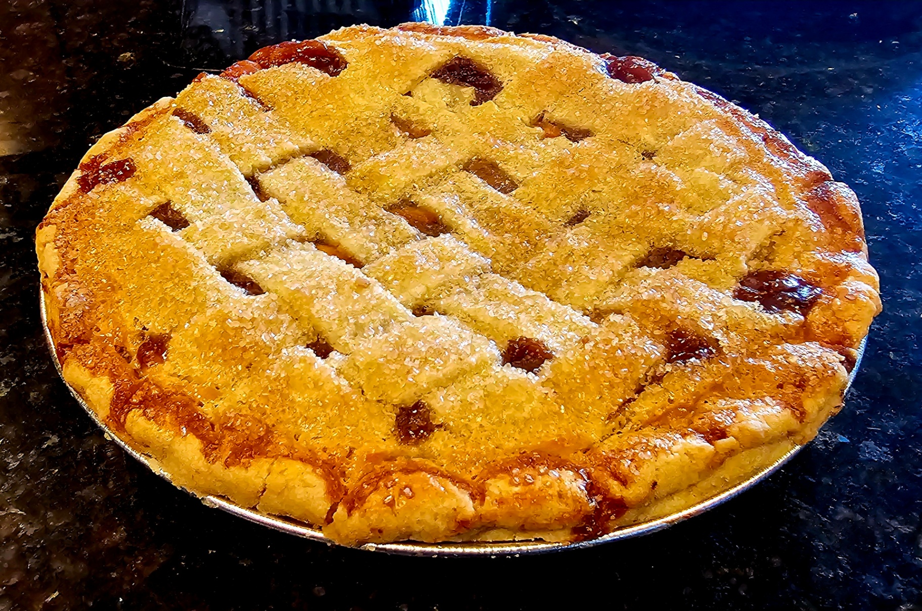 Golden lattice-top berry pie with sparkling sugared crust