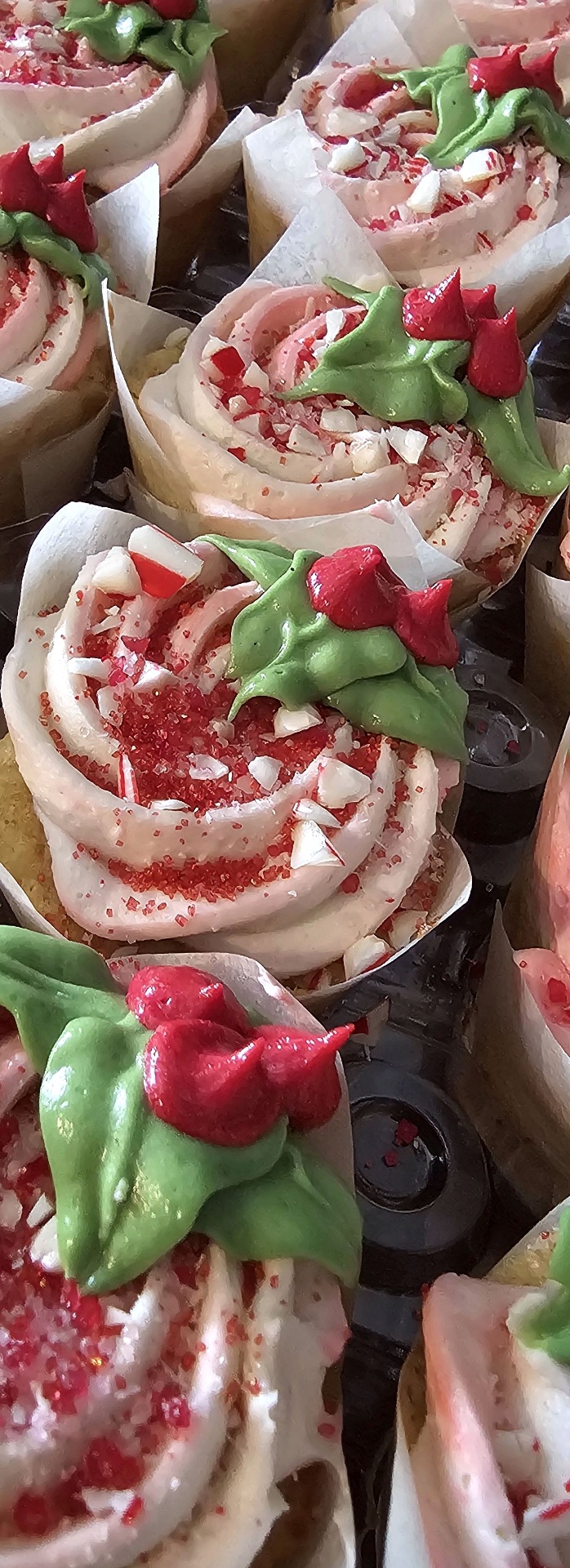 Holiday cupcakes with peppermint, holly, and berries