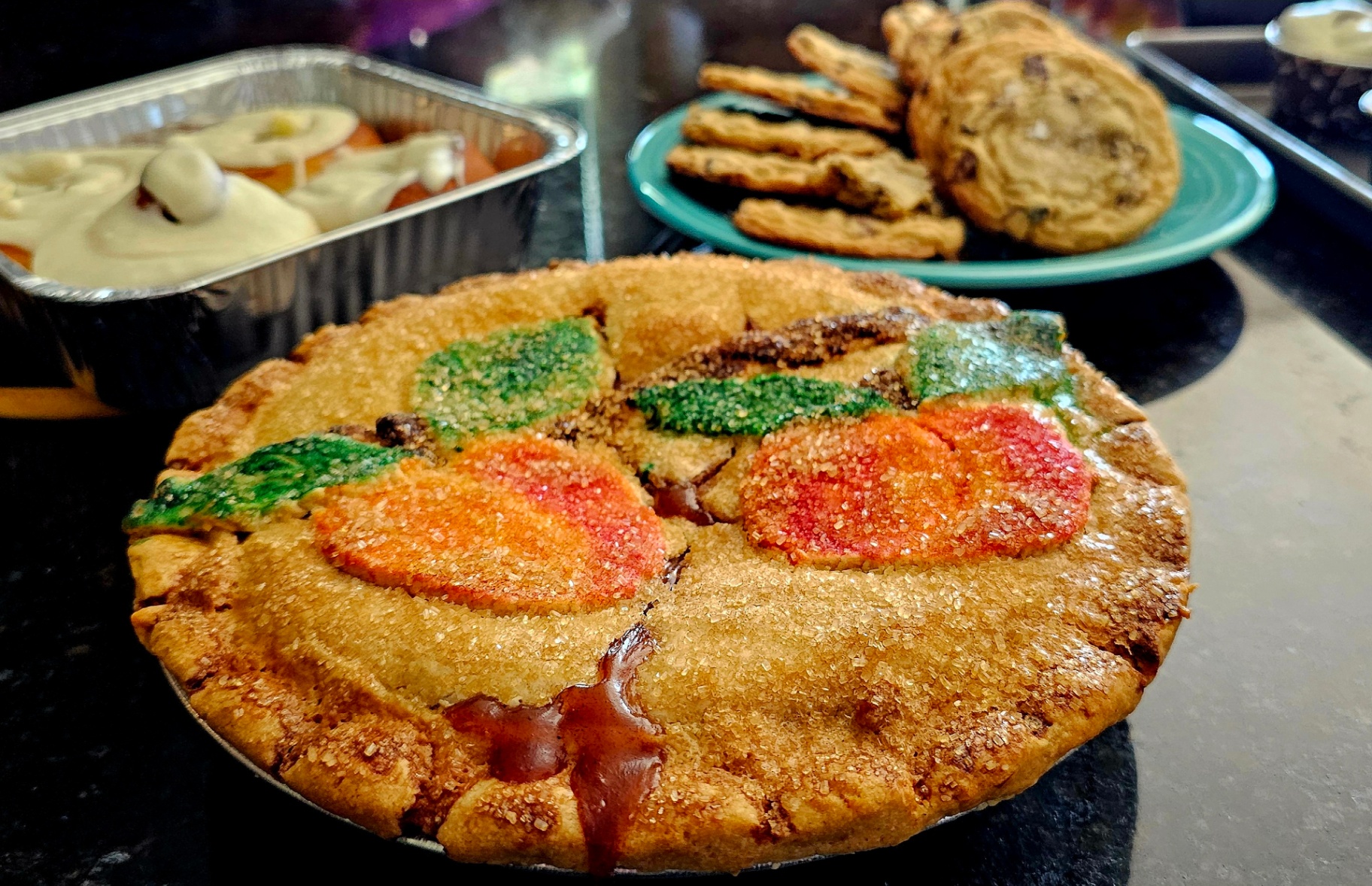 Pie with sugared crust and hand-painted pumpkin and leaf cutouts