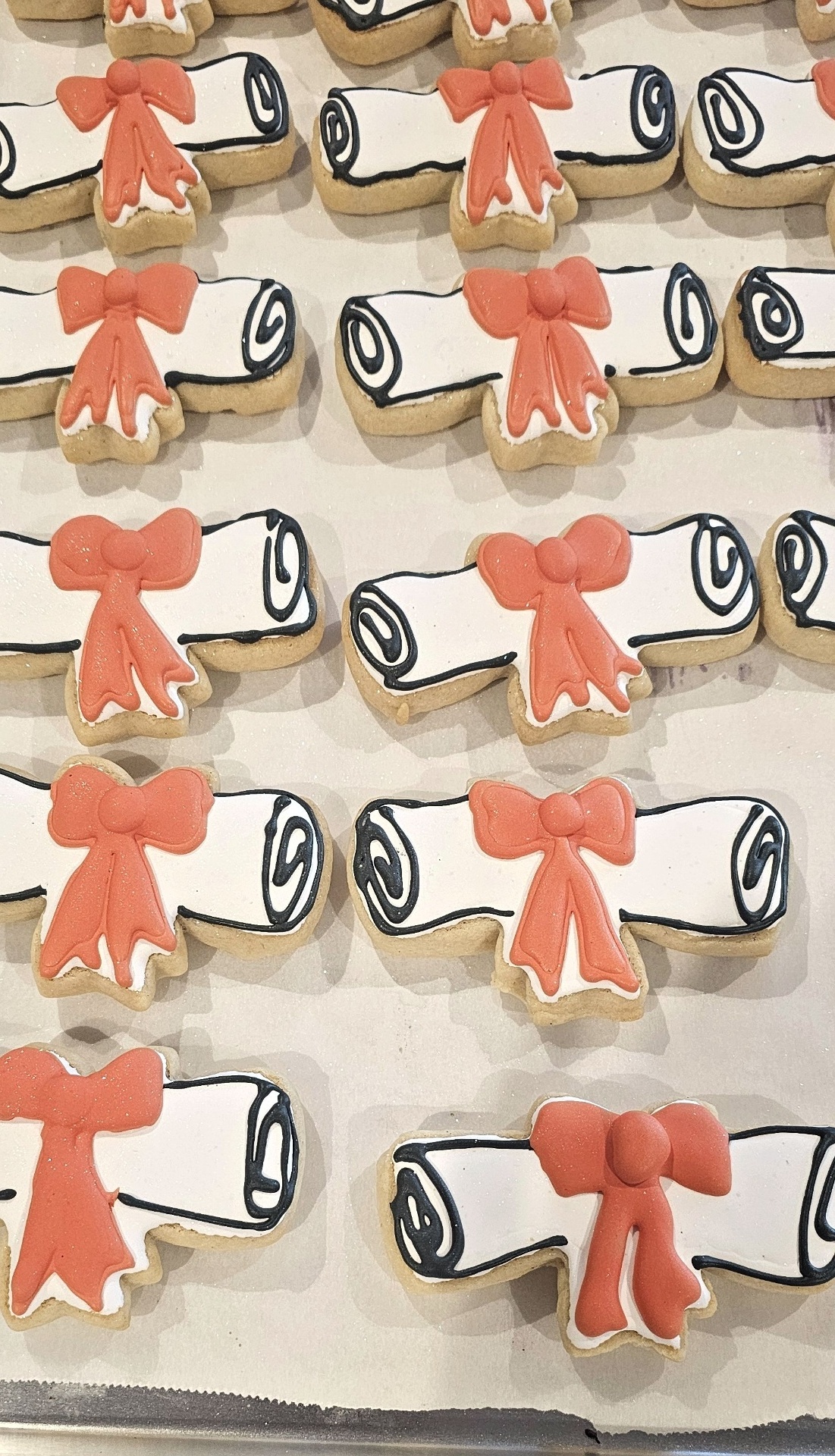 Coral bow and scroll cookies with royal icing