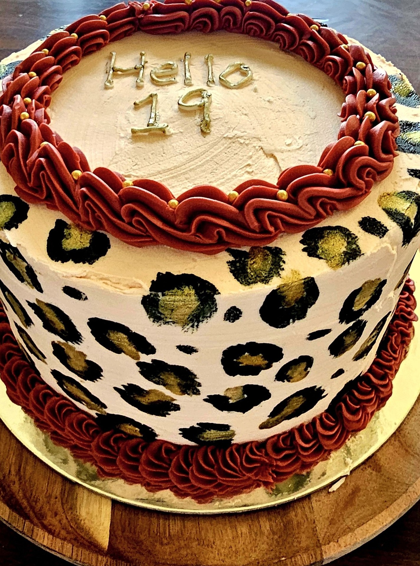 'Hello 19' birthday cake with hand-painted leopard print and burgundy piping