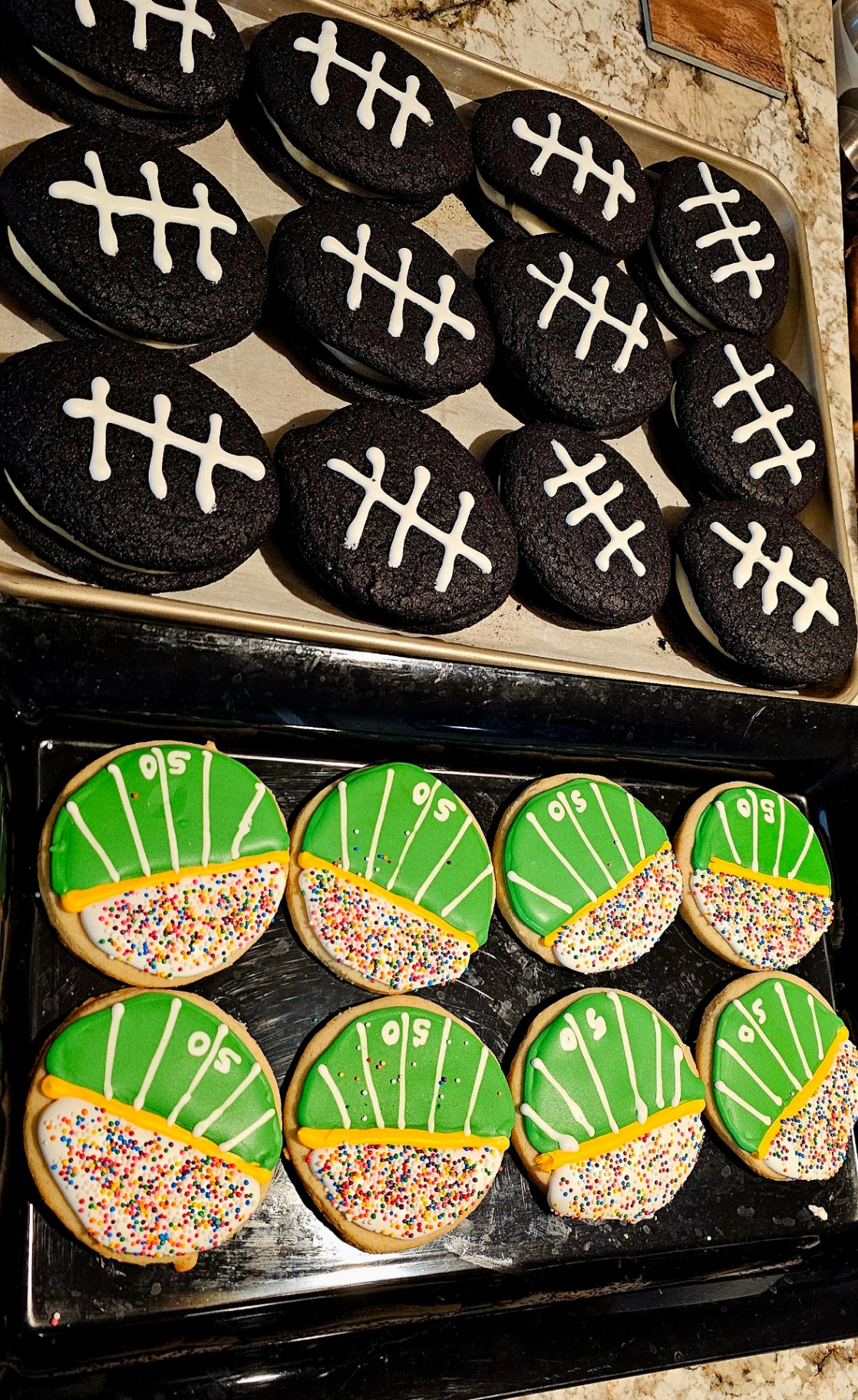Chocolate football whoopie pies with laces alongside 50-yard-line field cookies