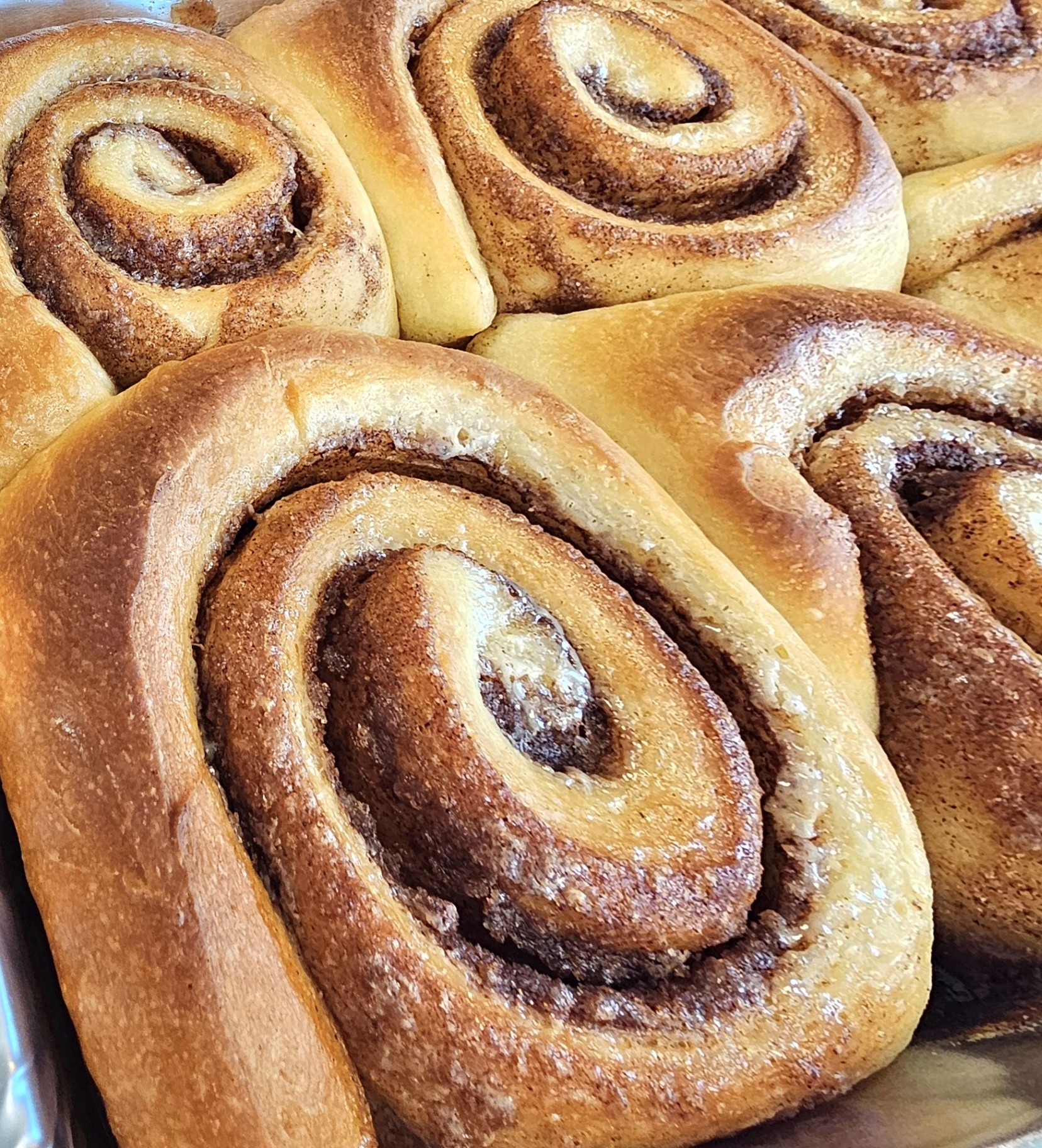 Close-up of giant cinnamon rolls fresh from the oven